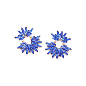 Detailed macro view of royal blue floral stud earrings with gold plating and crystals