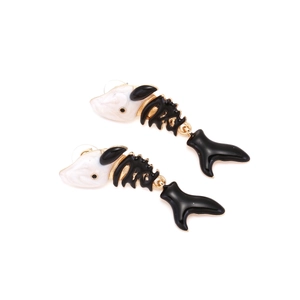 Detailed view of fish bone earrings with white marble resin and black enamel finish