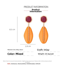 Detail showing 8.5cm long geometric resin earrings with dimensions and material specs