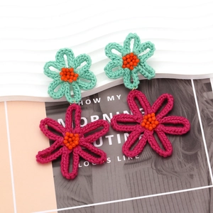 Handmade crochet flower earrings with mint green and rose red petals and orange beads