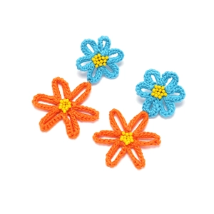 Handmade crochet flower earrings in blue and orange yarn with center yellow bead detail