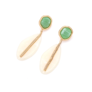 Detailed close-up of geometric resin earrings with green stones and ivory teardrop drops