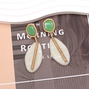 Fashionable geometric resin drop earrings with green accents and gold spiral links