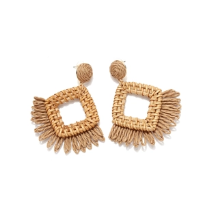 Bohemian raffia tassel earrings with square woven geometric design on white background