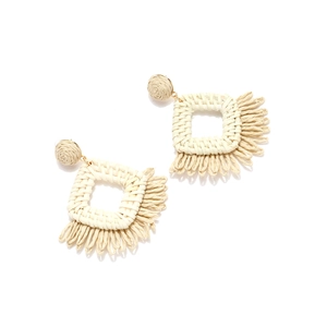 Detail of bohemian raffia drop earrings with cream woven fringes and square hollow design