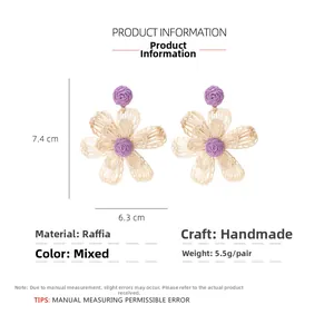 Detail view of handmade raffia flower earrings showing 7.4cm height and 6.3cm width