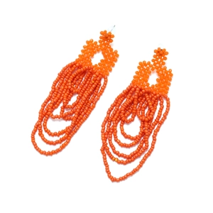 Detailed macro view of orange handmade bohemian seed bead tassel drop earrings