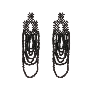 Handmade black seed bead tassel earrings with geometric bohemian weave on white background