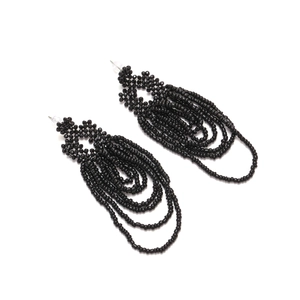 Detailed view of handmade black multi-layer beaded tassel earrings with geometric fringe