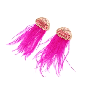 Detail of pink crystal fan-shaped gold earrings with vibrant magenta ostrich feathers