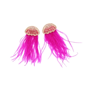 Detail of rose pink feather tassel earrings with shell-shaped crystal studded gold base