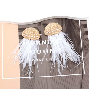 Long ostrich feather tassel earrings with gold pearl accents and bohemian style