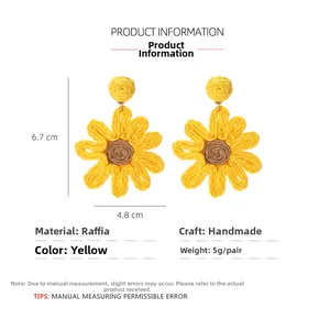 Detailed view of handmade raffia sunflower earrings with dimensions 6.7cm by 4.8cm