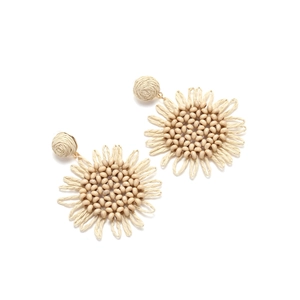Detailed view of handmade cream raffia woven sunflower earrings with bead embellishments