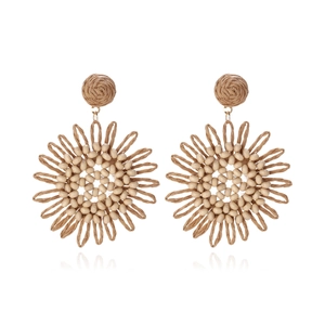 Bohemian raffia sunflower earrings with handmade beads and tassel detail on white background