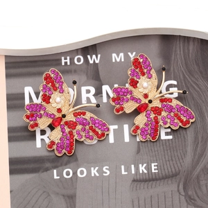 Colorful rhinestone butterfly earrings with faux pearls on a vintage gold metal base