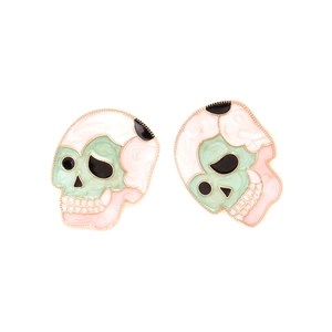Macro shot of colorful enamel skull stud earrings with polished gold outlines