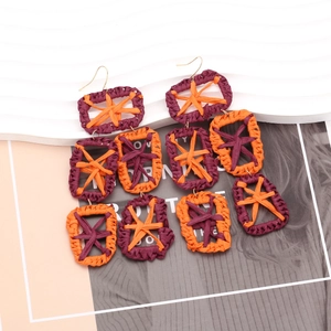 Bohemian oversized handmade raffia drop earrings with purple and orange geometric design