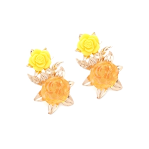 Retro resin flower earrings with amber petals and golden metal leaves on white background