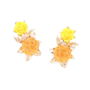 Detailed close-up of yellow resin rose earrings with delicate gold metal leaf accents