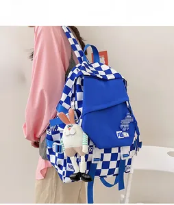 Blue and white checkered backpack with cute plush bunny charm and adjustable side buckles