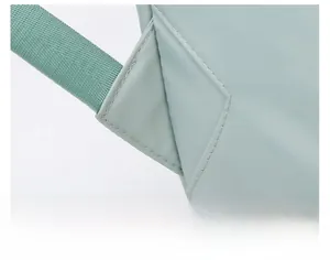 Detail view of reinforced stitching on the mint green bag strap for heavy duty support