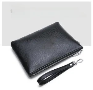 Detailed view of black PU leather clutch bag with litchi texture and silver hardware