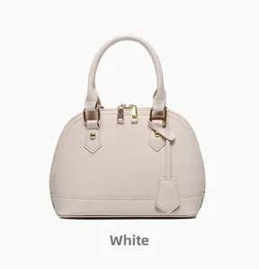 Detail of white shell handbag with crocodile texture and golden metal hardware