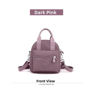 Front view of a dark pink mini nylon crossbody bag with zipper and adjustable straps