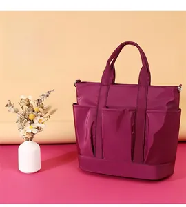 Detailed view of the purple nylon shoulder bag showing multiple functional pockets