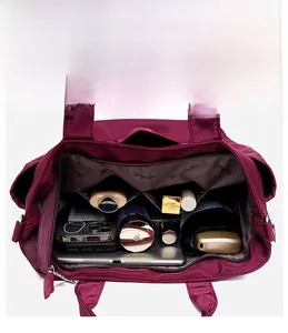 Detailed top view showing large capacity and internal compartments of the burgundy nylon bag