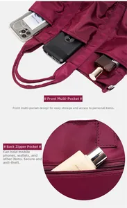 Detail view of burgundy nylon tote showing multi-pocket storage and anti-theft back pocket
