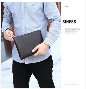 Detail showing high-quality dark brown PU leather texture and wrist strap of the clutch bag