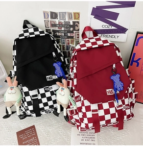 Detail of checkerboard backpacks with fashion patches and cute plush rabbit charms