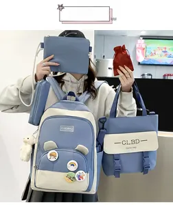 Close-up of a 5-piece student backpack set in sky blue and beige with cute bear pendant