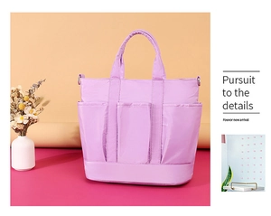 Detail of lavender nylon tote bag with functional pockets and glossy finish