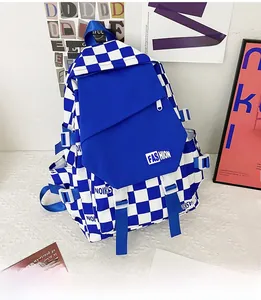 Detail view of the checkerboard backpack showing fashion labels and side buckle straps