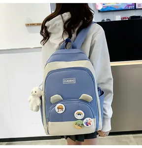 Detail of blue and white school backpack featuring cute ear decor and plush sheep charm