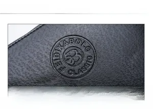 Detail showing the embossed Feidikabolo classic logo on black soft leather clutch bag