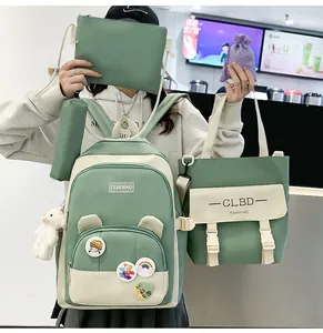 Detail view of 5-piece school backpack set in sage green and cream with cute bear charm