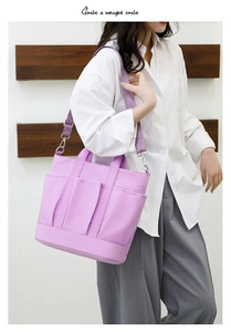 Detailed view of a purple nylon tote bag with multiple pockets and adjustable shoulder strap