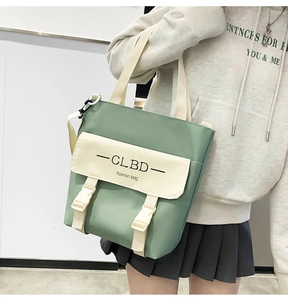 Detail view of bean green tote bag with adjustable strap and buckle closure