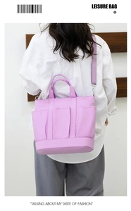Detail of purple nylon crossbody bag with multi-pocket design and adjustable shoulder strap