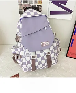 Detail of purple checkerboard backpack with large front pocket and fashion label