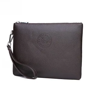 Detail of dark brown pebble leather clutch bag with silver zipper and embossed logo