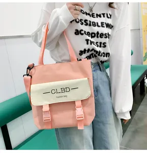 Pink and beige canvas crossbody tote bag with adjustable strap shown in casual setting