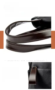 Detail of lychee pattern leather handbag with gunmetal hardware and brown strap