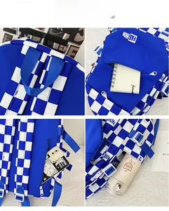 Detail of checkered backpack showing durable handle, front zipper pocket and side buckles