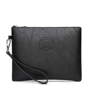 Close-up of black PU leather clutch bag with silver zipper and textured surface