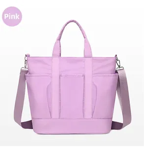 Macro detail of purple nylon crossbody bag showing multiple front pockets and strap